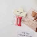 Set of 2 pink and red bone-shaped matte resin hair clips on a minimalist paper card - Girlish Pink Bone
