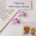 Close-up of two purple bow hair clips made of matte resin on a minimalist white desk - Matte Purple Pink (Plastic)