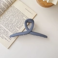 Detail shot of large matte grey-blue shark hair claw clip with dense teeth and elegant design - Matte Cross Style / Extra Large / Matte Haze Blue
