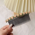 Detail view of a floral hair comb with ten small pink flowers and black teeth for girls - Pink Flower Hair Comb
