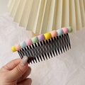 Close-up of a girl's hair comb clip with colorful macaron beads for fringe styling - Square Bead Hair Comb