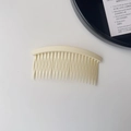 Macro view of a cream-colored hair side comb for neat styling and securing flyaways - Plain Hair Comb - Ivory White
