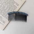 Detail of multi-tooth hair comb with blue and silver rhinestones on a vintage book - Rhinestone Style / Rhinestone Hair Comb - Blue