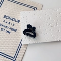 Detail of a black resin heart hair claw with gold Barrette La France text and metal spring - Black