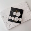 Detail of two iridescent resin hair clips on a decorative card, showing pearly texture - One Pair / White