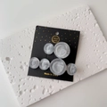 Detailed close-up of grey marble resin hair clips on a black handmade card display - One Pair / Gray