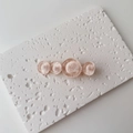Detail showing high-gloss pink water-ripple resin circles on a gold-tone hair clip base - Single Piece / Large / Light Pink