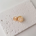 Detail of amber water ripple resin hair clip with dual circle geometric design - Single Piece / Small / Orange