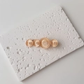Macro detail of amber resin circles on elegant gold metal hair clip for women - Single Piece / Large / Orange