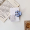 Detail of candy-colored pumpkin hair claws in matte blue and clear finish on card - Matte Blue and Transparent Glossy Combo / Blue Series