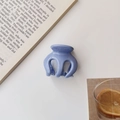Close-up of a blue glossy pumpkin-shaped hair claw clip on an aesthetic book background - Shiny Blue / Blue
