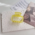 Detailed macro view of the pastel yellow matte hair claw clip with a hollow rectangle design - Yellow
