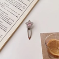 Detalle de una pinza para el pelo de estrella con cristal rosa y diamantes plateados - Estrella de Strass Rosa