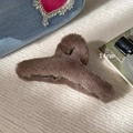 Detail view of a 14cm large brown plush hair claw clip on a stylish textured background - Cross Claw Clip / Brown