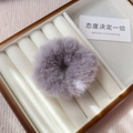 Close-up of soft purple plush scrunchie made of faux mink fur in a wooden jewelry box - Light Gray