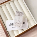 Close-up of matte ivory rectangular hair claw clip with brown silk texture in a box - Jelly Small Claw / White