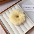 Close-up of bright yellow plush hair scrunchie in a premium jewelry display box - Creamy Yellow