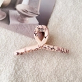 Macro shot of large pink marble shark hair clip on white faux fur and lifestyle magazine - Medium-Light Pink