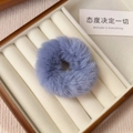 Close-up of soft lavender plush faux fur scrunchie in a premium wooden jewelry display box - Blue