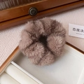 Detailed view of a soft brown faux mink fur scrunchie in an elegant jewelry storage box - Small-Coffee