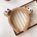 Dettaglio di una fascia per capelli marrone in peluche con grandi occhi animati - Fascia Stile Mostro Marrone
