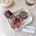 Detail of candy color elastic hair bands spilling from transparent bottle onto tray - Brown