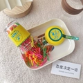 Macro detail of colorful candy-colored disposable rubber bands in a transparent bottle - Yellow