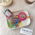 Close-up of 130pcs colorful mixed elastic hair bands stored in a clear cylinder container - Rose Red