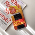 Pack de 10 gomas negras para el pelo de alta elasticidad sobre un libro con luz natural - Serie Negra