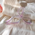 Detail showing iridescent pink bow-shaped hair claw with metal spring on silk background - Pink (AB Color)