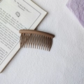 Close-up of matte coffee brown hair comb showing fine frosted texture and curved teeth - Round Head Afro Comb / Khaki