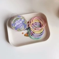 Detail of colorful macaron elastic hair bands set in a clear floral storage box - Macaron Series