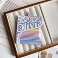 Detailed view of 10-piece high-elasticity candy-colored hair ties in a luxury velvet box - Creamy Vanilla