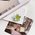 Close-up of a gradient mint green resin flower hair claw clip on a stone slab - Sky Blue Flower