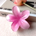 Pink plumeria hair claw clip with a glossy translucent resin finish and shimmer - Pink