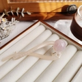 Minimalist beige resin hair claw clip with pink pearl accent on a velvet tray - Creamy White (Full Pearl)