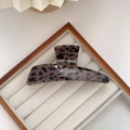 Detailed view of polished leopard print hair claw clip on beige jewelry tray - Dark Coffee Irregular Claw Clip