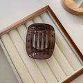 Detail of square amber tortoiseshell claw clip with strong metal spring on velvet - Small / Gray