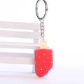 Macro shot of red popsicle keychain made of soft silicone on a mini white stool - 3CM+5CM / Red