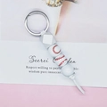 Detail of white baseball keychain with red stitching patterns and silver metal ring - Baseball (White)