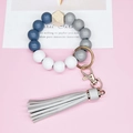 Detail of wooden and silicone beaded wristlet keychain with grey leather tassel and gold clasp - Gray