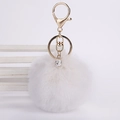 Macro view of white faux rabbit fur pom pom keychain with gold lobster clasp and crystal bead - 8cm Pompom / White