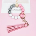 Detail of pink tassel keychain with silicone beads and a geometric wooden bead - Pink