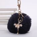 Détail de pompon en fausse fourrure bleu marine avec pendentif ballerine dorée - Pompon de 8 cm / Bleu Marine