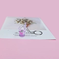 Detailed view of mini purple drink keychain with flowing glitter and strawberry charm - Purple