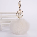 Detail of a white faux fur pompom keychain with a sparkling crystal ball and gold lobster clasp - 8cm Pompom / Off-white
