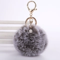 Detail of taupe faux rabbit fur keychain with a sparkling rhinestone ball and gold clasp - 8cm Pompom / Two-tone Grey