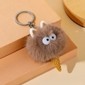 Detailed view of plush ice cream cat keychain with soft brown fur and metallic ring - Brown
