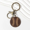 Baseball wood keychain with engraved stitches and bronze lobster clasp on white background - Brown Wheat Baseball Wood