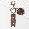Wooden MOM keychain with basketball design on white textured background - Basketball Style